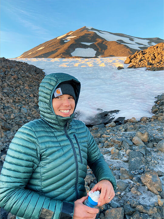 Woman standing near a mountain