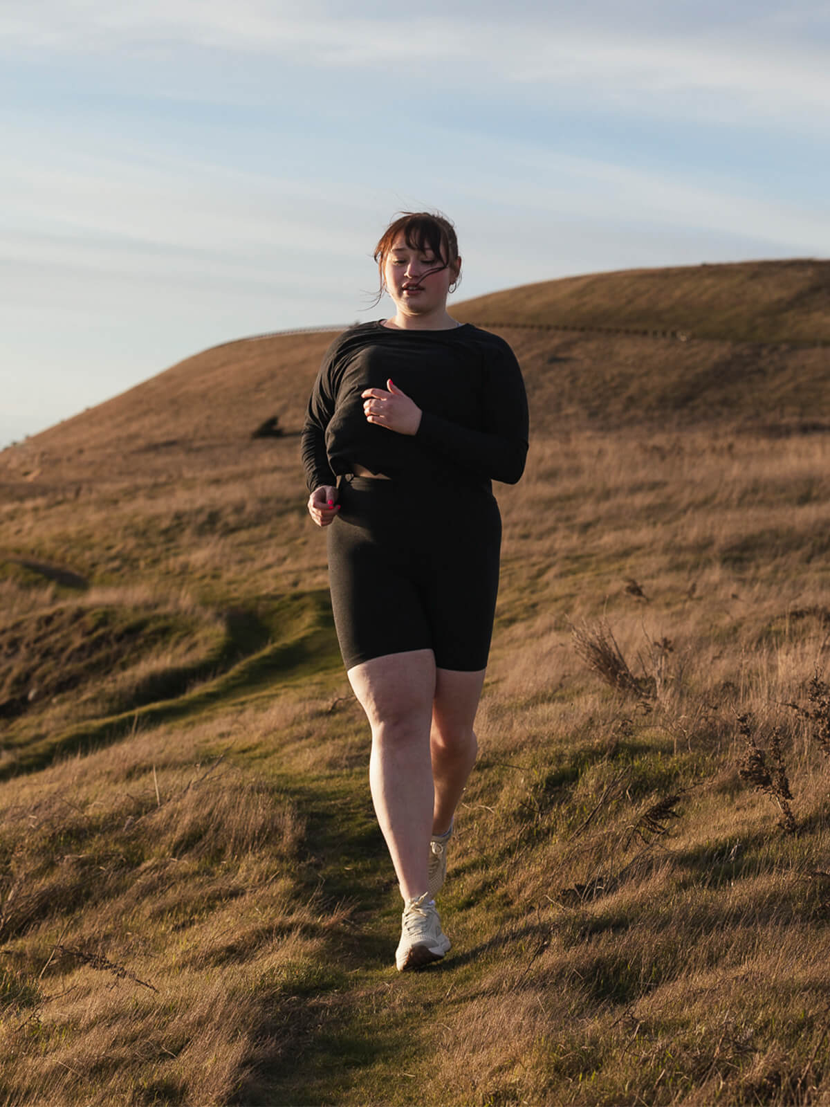 A woman wearing Frozen Dew Hilma running shoes running