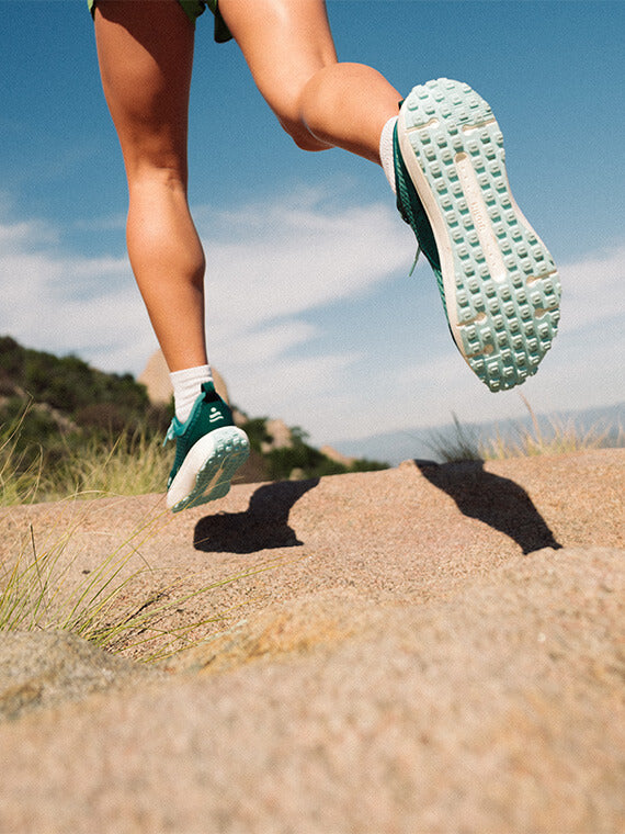 Person running in Evergreen Hilma running shoes