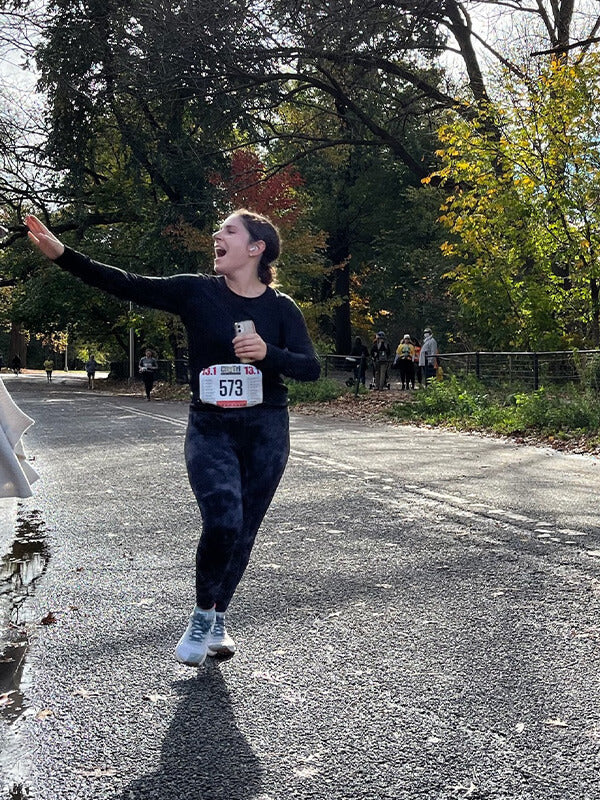 Woman running in a race wearing Hilma Running Shoes. Hilma Running Instagram Page.