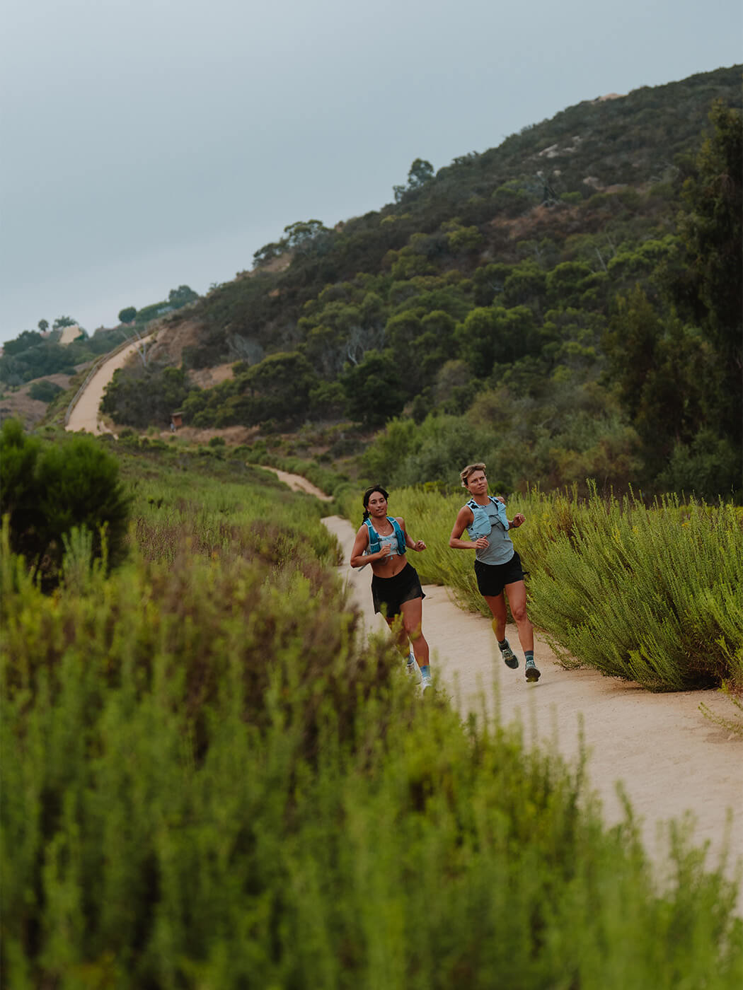 Two women running on a trail