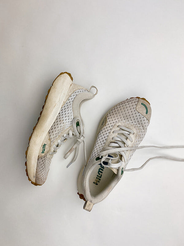 Well worn pair of white Hilma Running shoes. Hilma Running Instagram Page.