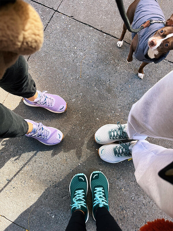 Friends with their dog all wearing Hilma Running Shoes. Hilma Running Instagram Page.